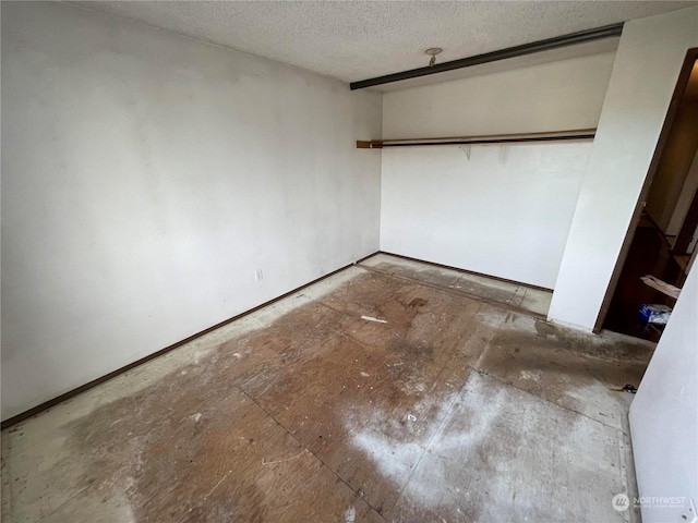 unfurnished room featuring a textured ceiling