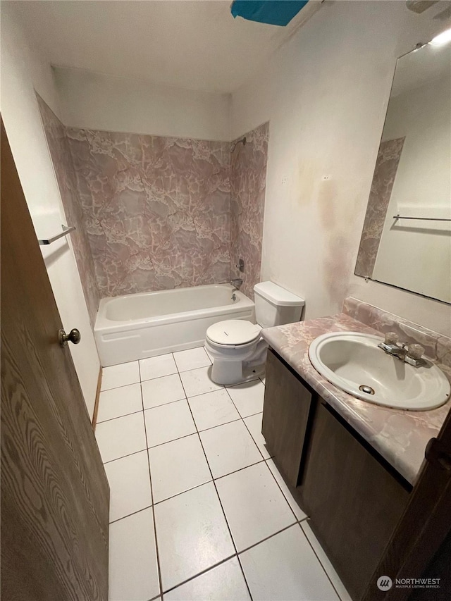 full bathroom with tile patterned flooring, vanity, tiled shower / bath, and toilet