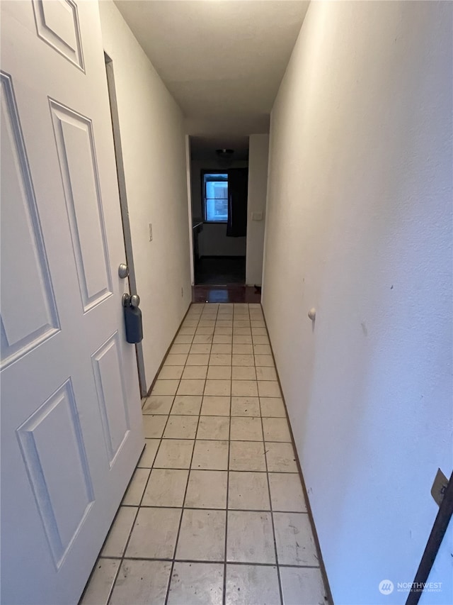 hallway featuring light tile patterned floors