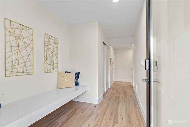 hall with light hardwood / wood-style flooring