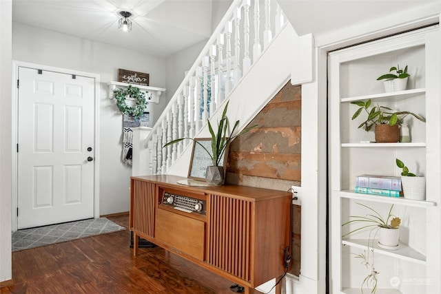 entryway with dark hardwood / wood-style flooring