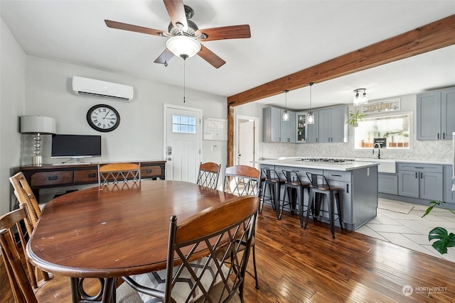 dining space featuring beamed ceiling, plenty of natural light, dark wood-type flooring, and a wall mounted AC