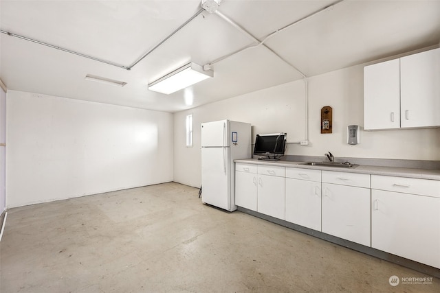 kitchen with sink, white cabinets, and white refrigerator