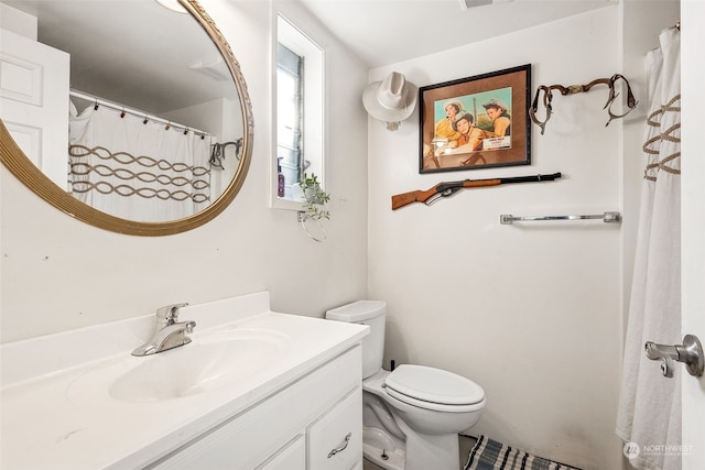 bathroom featuring vanity and toilet