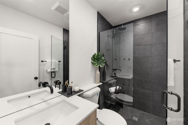 bathroom featuring walk in shower, vanity, and toilet