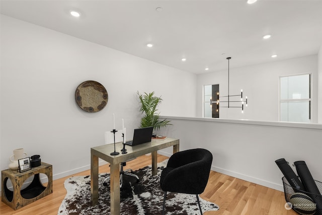 office space with a notable chandelier and light wood-type flooring