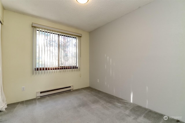 carpeted empty room featuring a textured ceiling and a baseboard heating unit