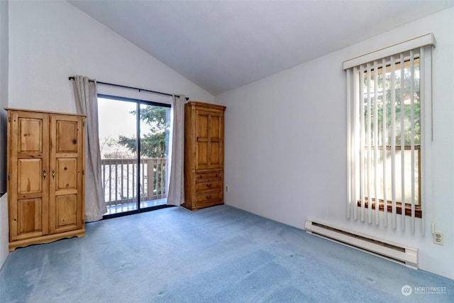 carpeted empty room featuring lofted ceiling and a baseboard radiator