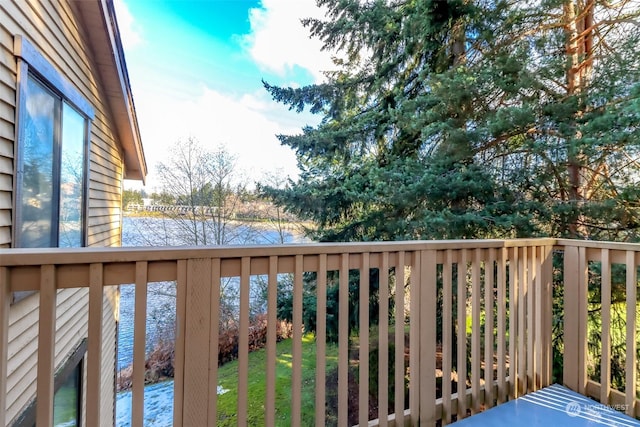 balcony featuring a deck with water view