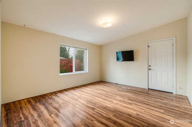 empty room with light hardwood / wood-style floors