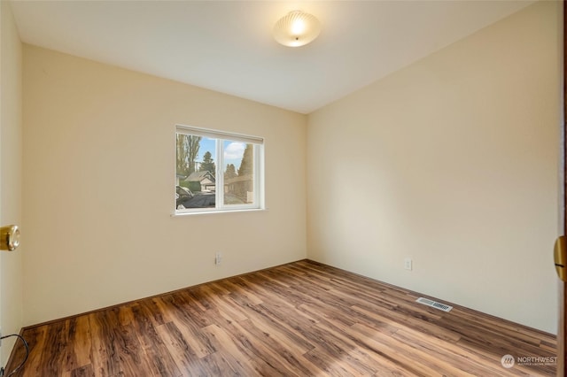 unfurnished room with hardwood / wood-style flooring