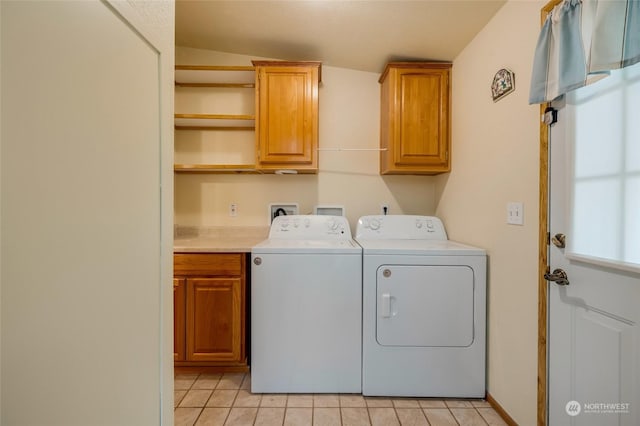 washroom featuring cabinets, light tile patterned flooring, and independent washer and dryer