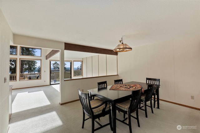 dining area featuring beam ceiling