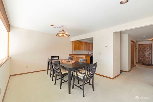 dining area featuring light colored carpet