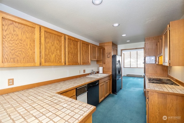 kitchen featuring sink, a baseboard heating unit, black appliances, light carpet, and tile countertops