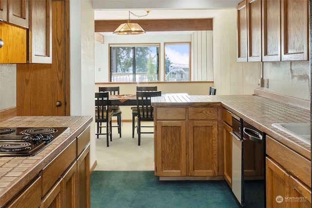 kitchen featuring dishwashing machine, black cooktop, dark carpet, tile countertops, and decorative light fixtures