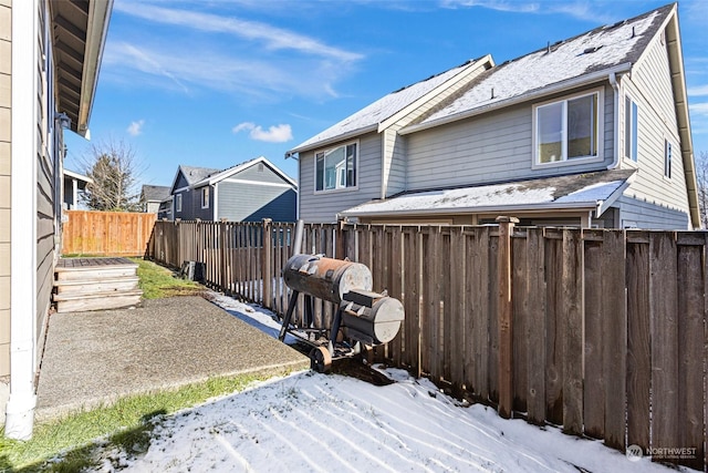 snow covered property with a patio area