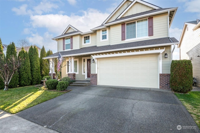 craftsman-style home featuring a garage and a front yard