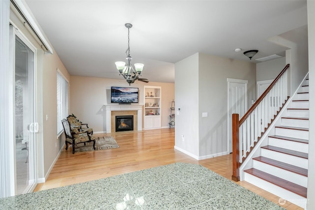 living room featuring an inviting chandelier and wood-type flooring