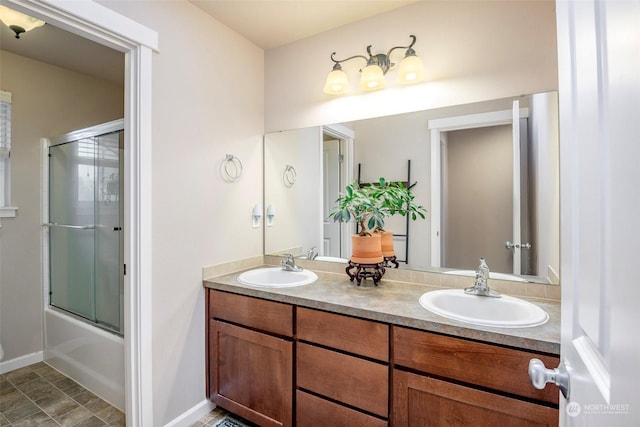 bathroom featuring enclosed tub / shower combo and vanity