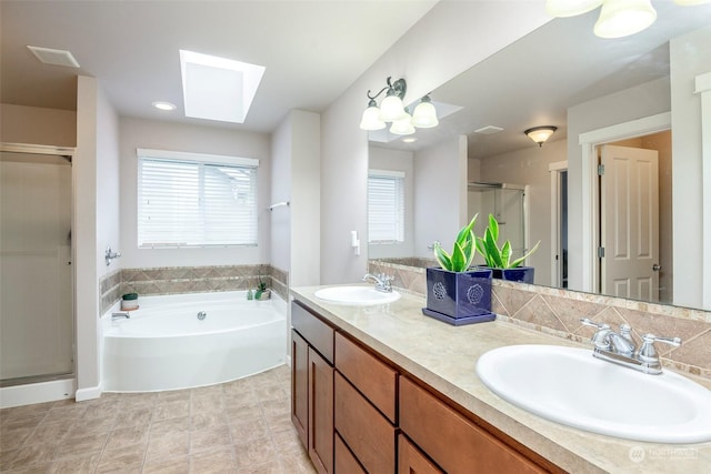 bathroom with vanity, a skylight, and plus walk in shower