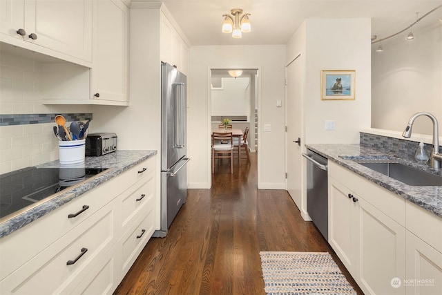 kitchen with dark wood-type flooring, sink, white cabinetry, light stone counters, and stainless steel appliances