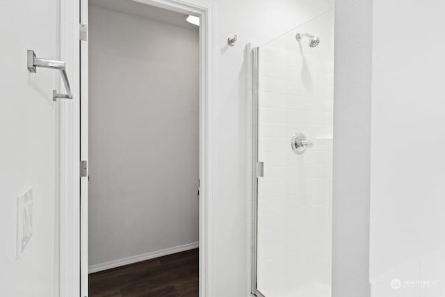 bathroom featuring an enclosed shower and hardwood / wood-style floors