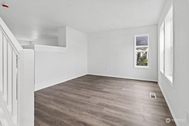 empty room with dark hardwood / wood-style floors