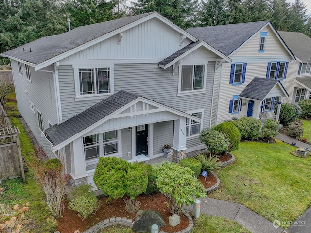 view of front of property with covered porch and a front yard