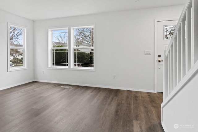 foyer entrance with dark hardwood / wood-style floors