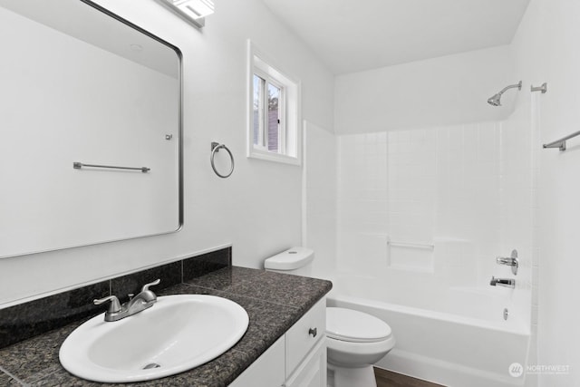 full bathroom with vanity, toilet, and  shower combination