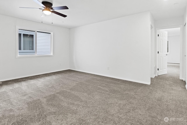 carpeted spare room featuring ceiling fan