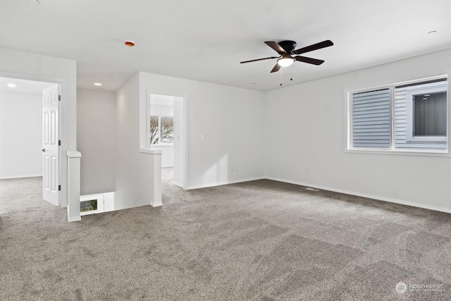 carpeted empty room featuring ceiling fan