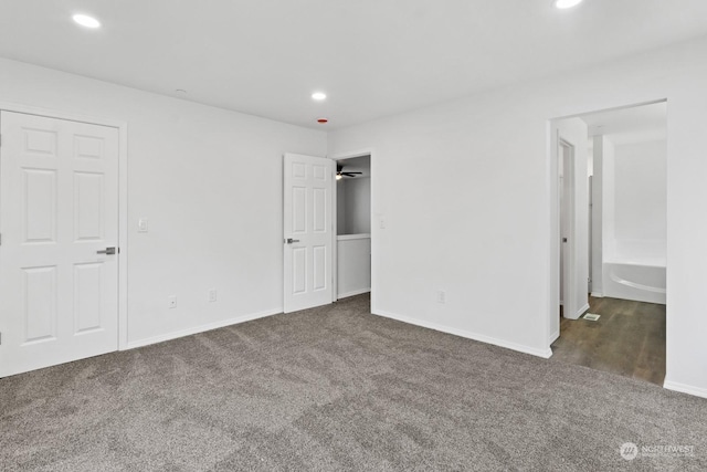 unfurnished bedroom featuring dark colored carpet