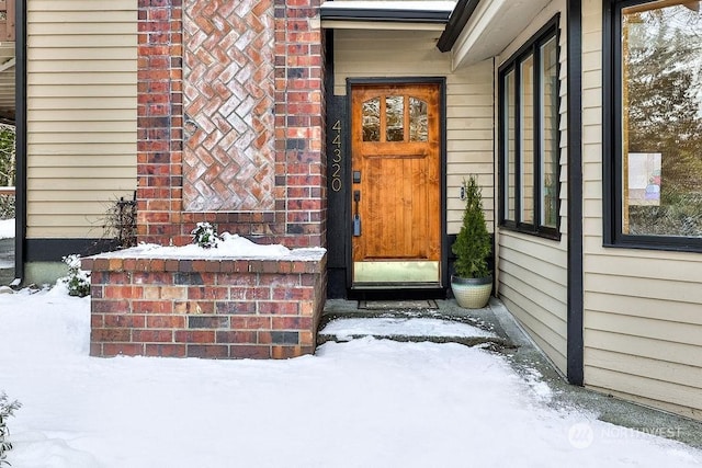 view of snow covered property entrance