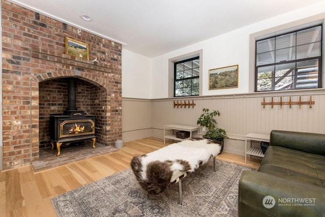 living room featuring a wood stove and hardwood / wood-style floors