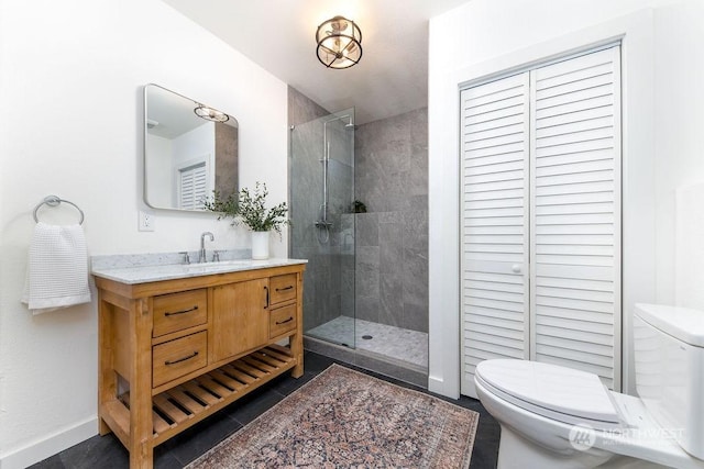 bathroom featuring tile patterned flooring, vanity, an enclosed shower, and toilet