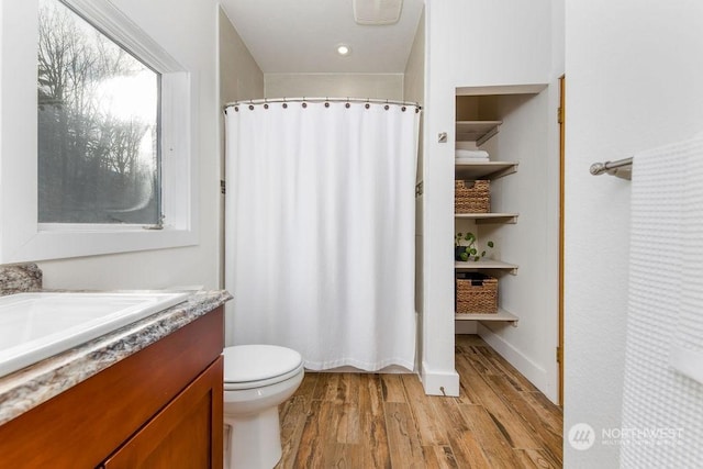 bathroom with vanity, hardwood / wood-style floors, and toilet