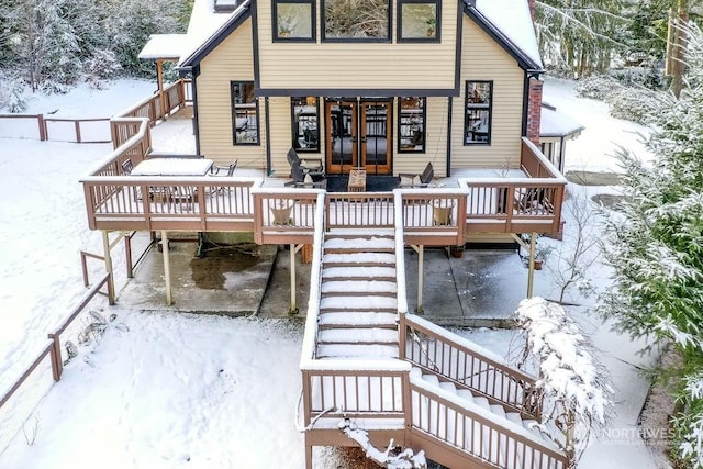 snow covered property featuring a wooden deck