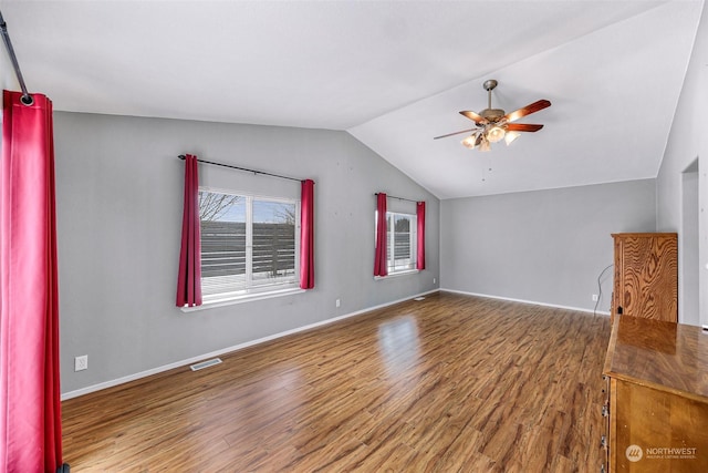 interior space with ceiling fan, wood-type flooring, and vaulted ceiling