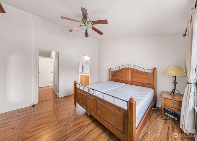 bedroom featuring ceiling fan, connected bathroom, and light hardwood / wood-style floors