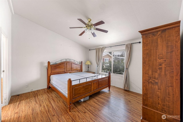 bedroom featuring vaulted ceiling, ceiling fan, and light hardwood / wood-style floors