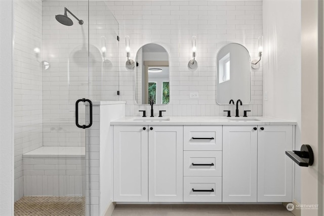 bathroom featuring vanity and an enclosed shower