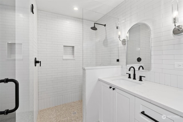 bathroom with vanity and a shower with shower door