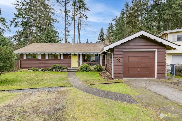 ranch-style home with a garage and a front yard