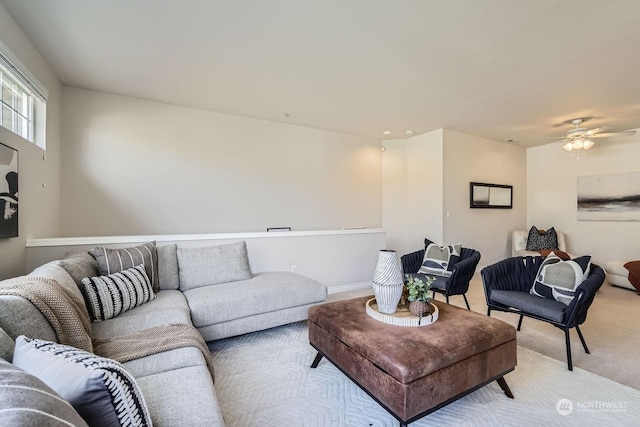 carpeted living room with ceiling fan