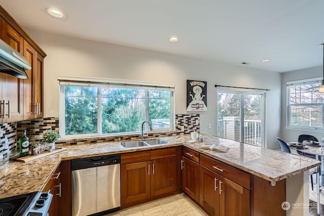 kitchen featuring sink, stainless steel dishwasher, kitchen peninsula, light stone countertops, and stove