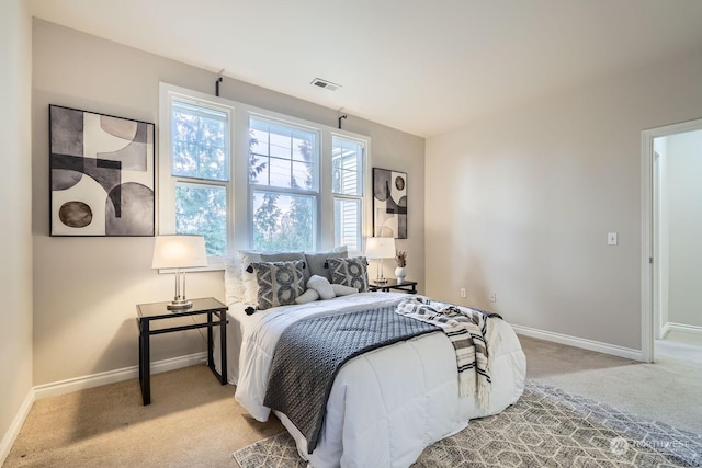 bedroom featuring light carpet