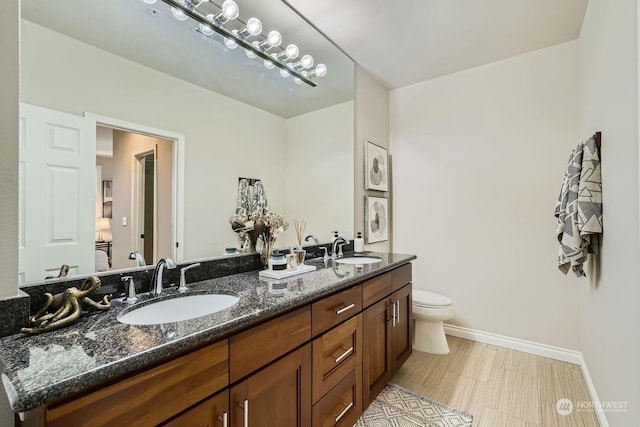 bathroom featuring vanity and toilet