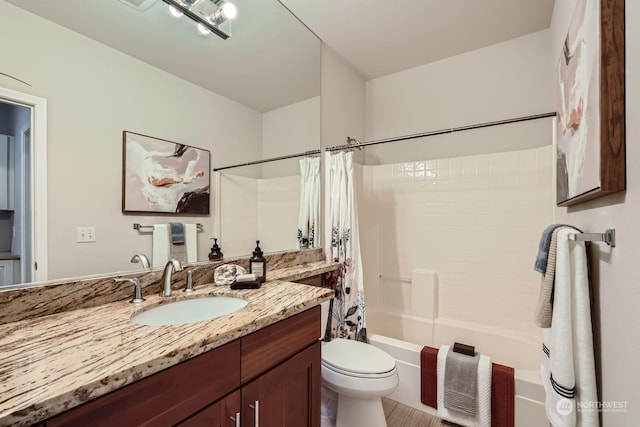 full bathroom featuring vanity, shower / bathtub combination with curtain, and toilet